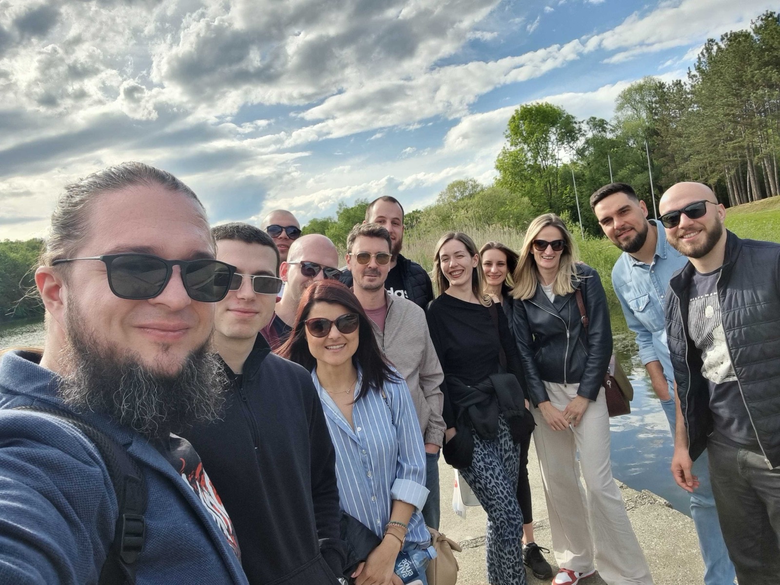 Hurricane Studio team gathered by a lake